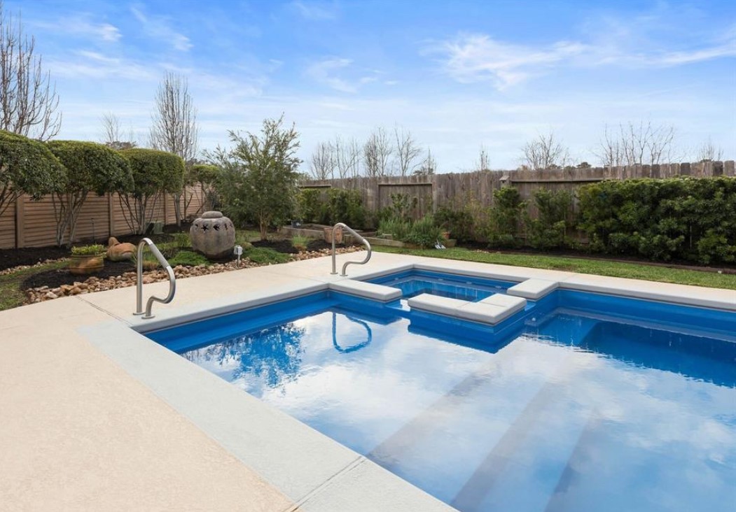 9039 Centennial Drive Conroe, TX 77384 - Photo 14 of 16 a view of a swimming pool with a lounge chair