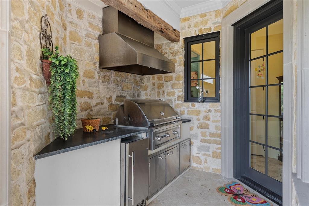 4101 Howard Road Waxahachie, TX 75165 - Photo 22 of 40 The gas grill is tucked away in a wing of the patio with its own vent a hood to keep the smoke from entering the patio.