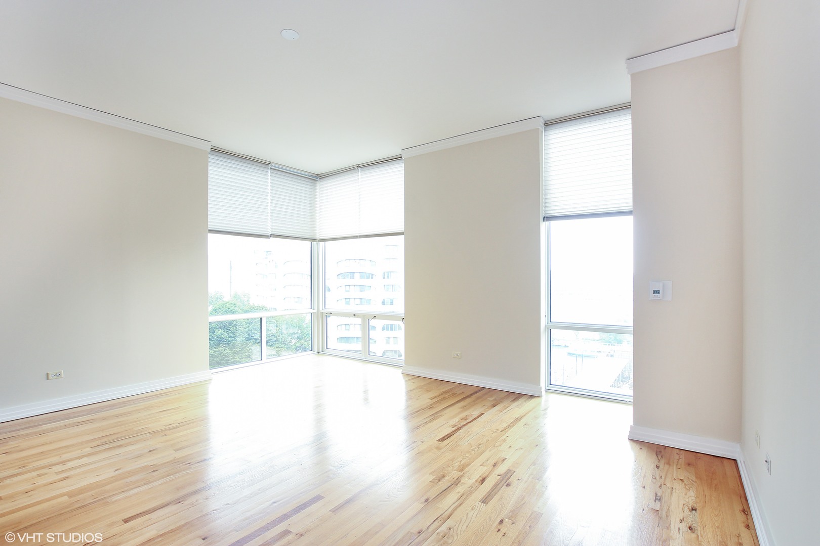 170 West Polk Street, Unit 904 Chicago, IL 60605 - Photo 3 of 10 an empty room with wooden floor and windows