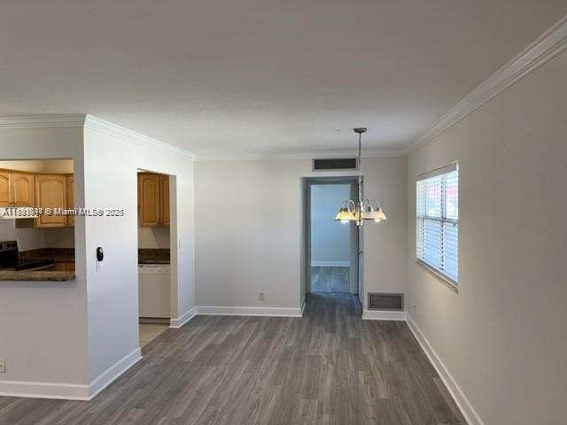 594 Saxony M, Unit 594 Delray Beach, FL 33446 - Photo 2 of 9 wooden floor in an empty room with a window