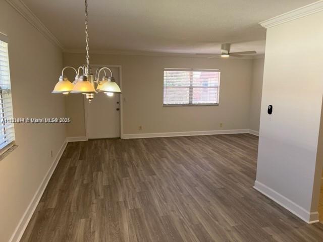 594 Saxony M, Unit 594 Delray Beach, FL 33446 - Photo 3 of 9 an empty room with wooden floor and windows