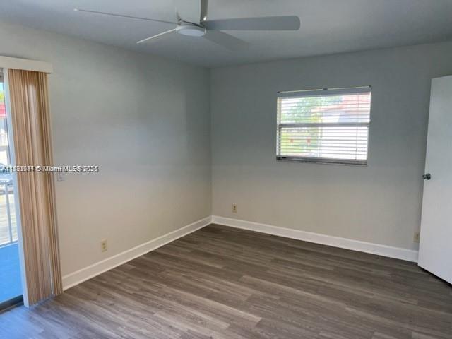 594 Saxony M, Unit 594 Delray Beach, FL 33446 - Photo 7 of 9 wooden floor in an empty room with a window