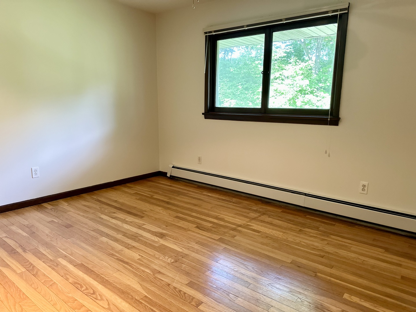 1453 North 2401st Road Ottawa, IL 61350 - Photo 12 of 26 a view of an empty room with wooden floor and a window