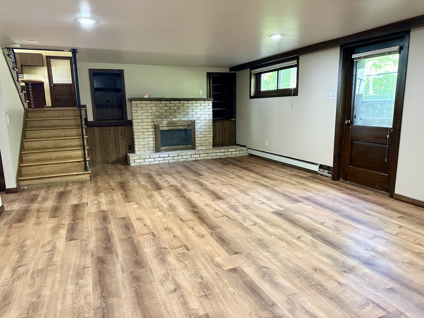 1453 North 2401st Road Ottawa, IL 61350 - Photo 9 of 26 a view of an empty room with wooden floor and a fireplace
