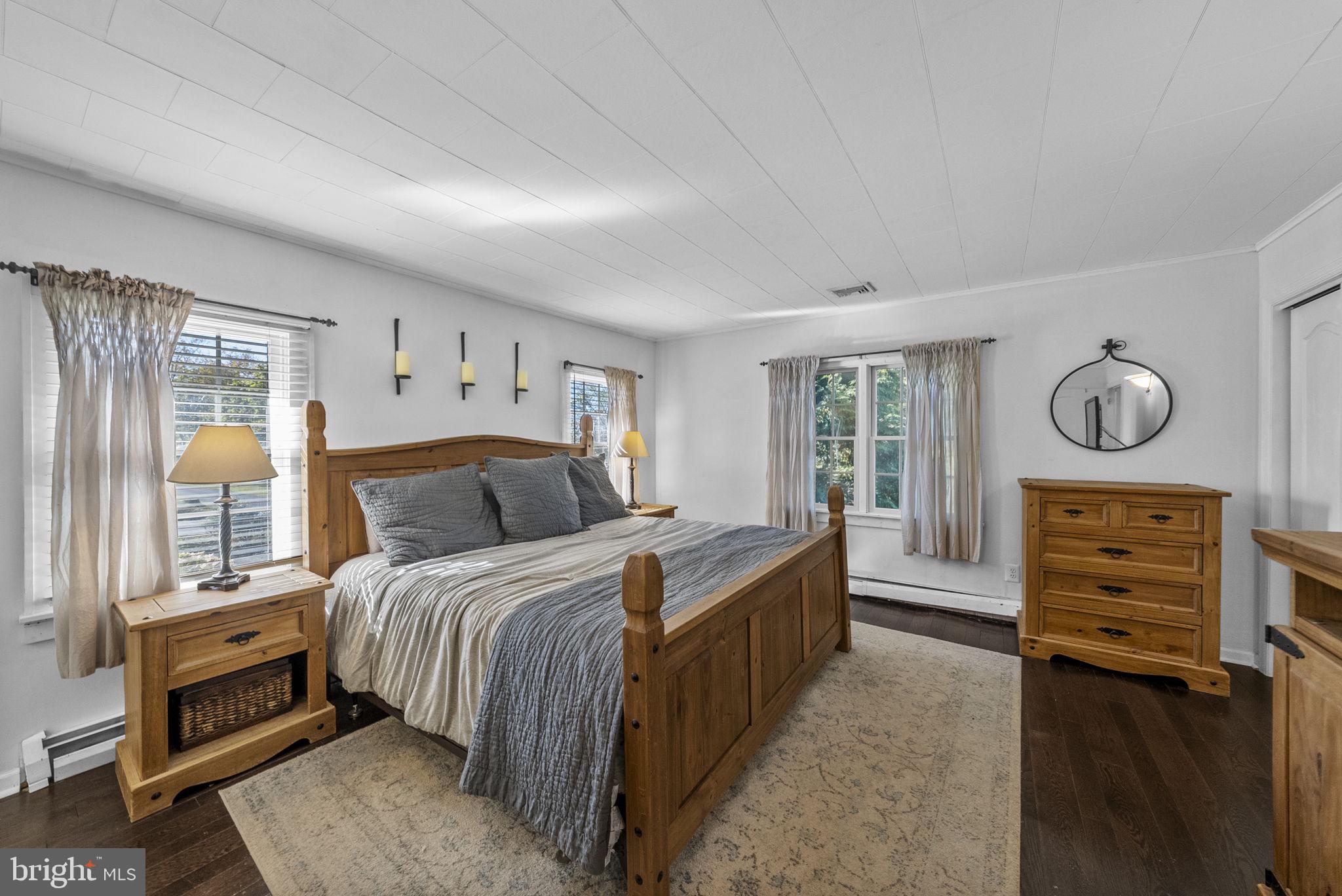 623 Montgomery Road Hillsborough, NJ 08844 - Photo 25 of 67 a bedroom with a bed a mirror on dresser and a window