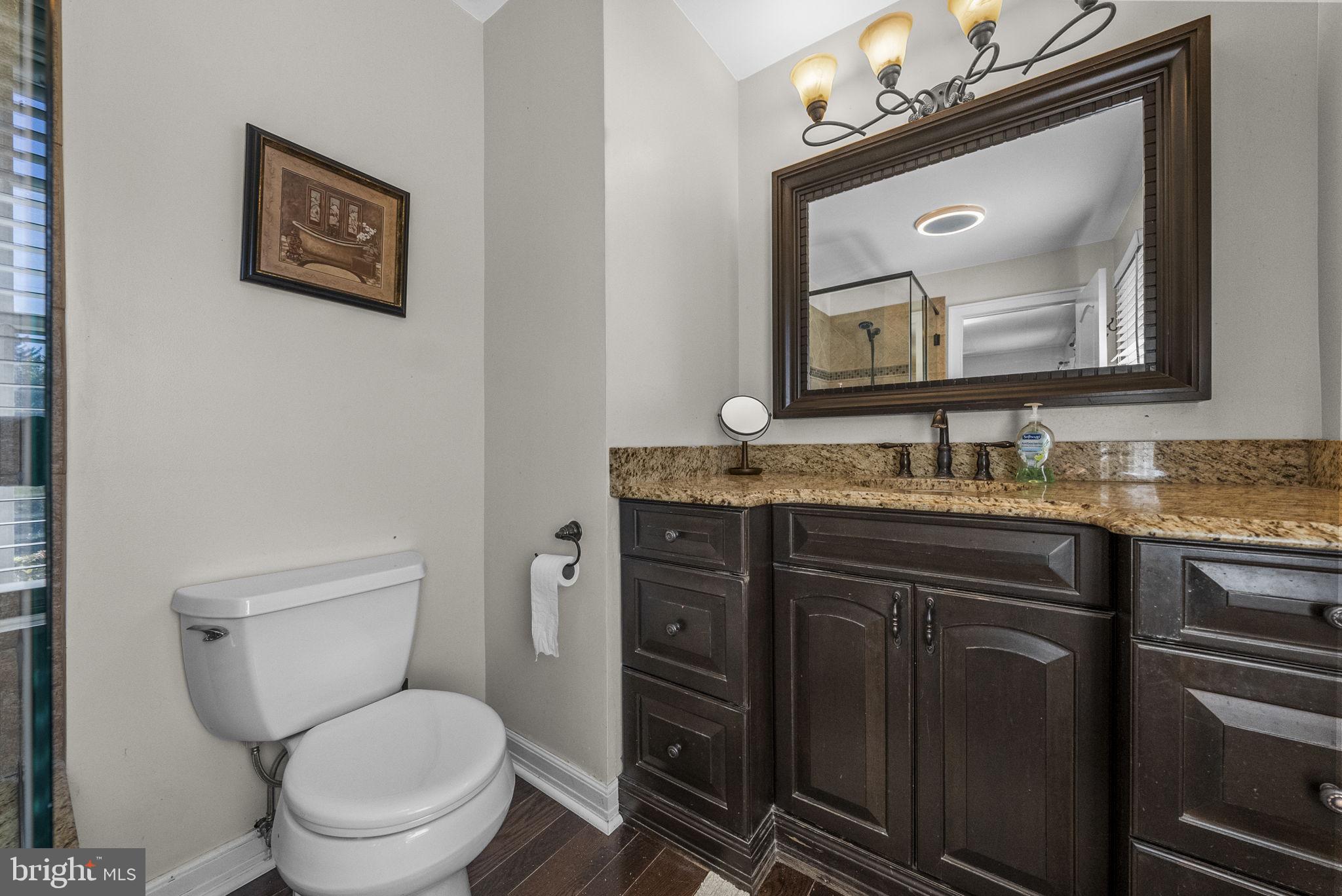623 Montgomery Road Hillsborough, NJ 08844 - Photo 27 of 67 a bathroom with a granite countertop toilet sink and mirror