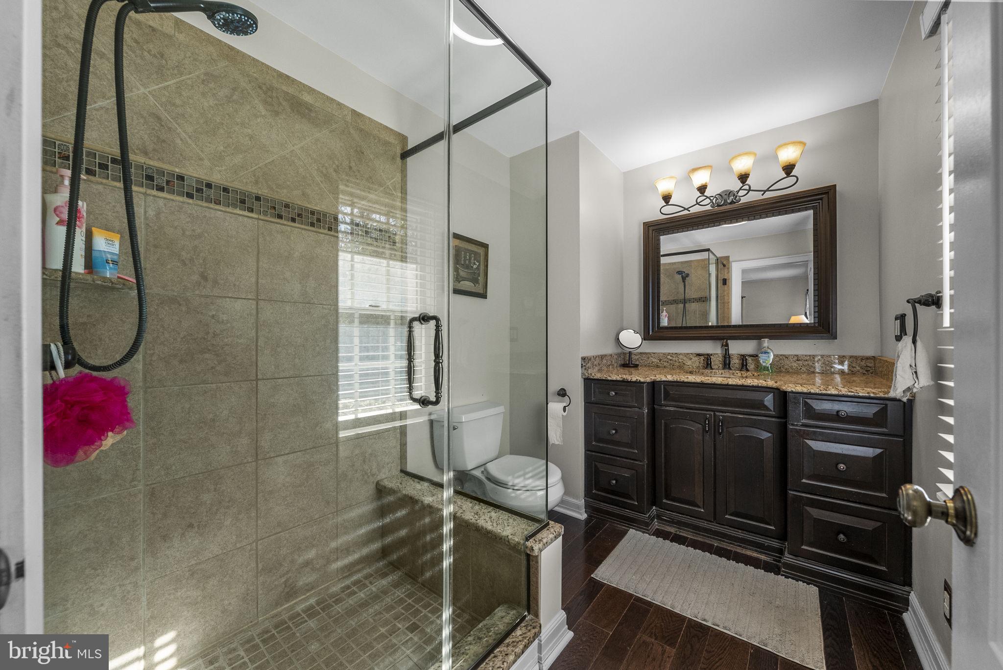 623 Montgomery Road Hillsborough, NJ 08844 - Photo 28 of 67 a bathroom with a sink mirror and a shower