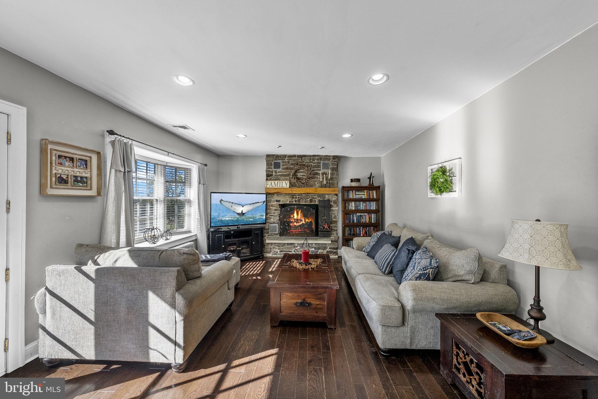 623 Montgomery Road Hillsborough, NJ 08844 - Photo 39 of 67 a living room with fireplace furniture and a wooden floor