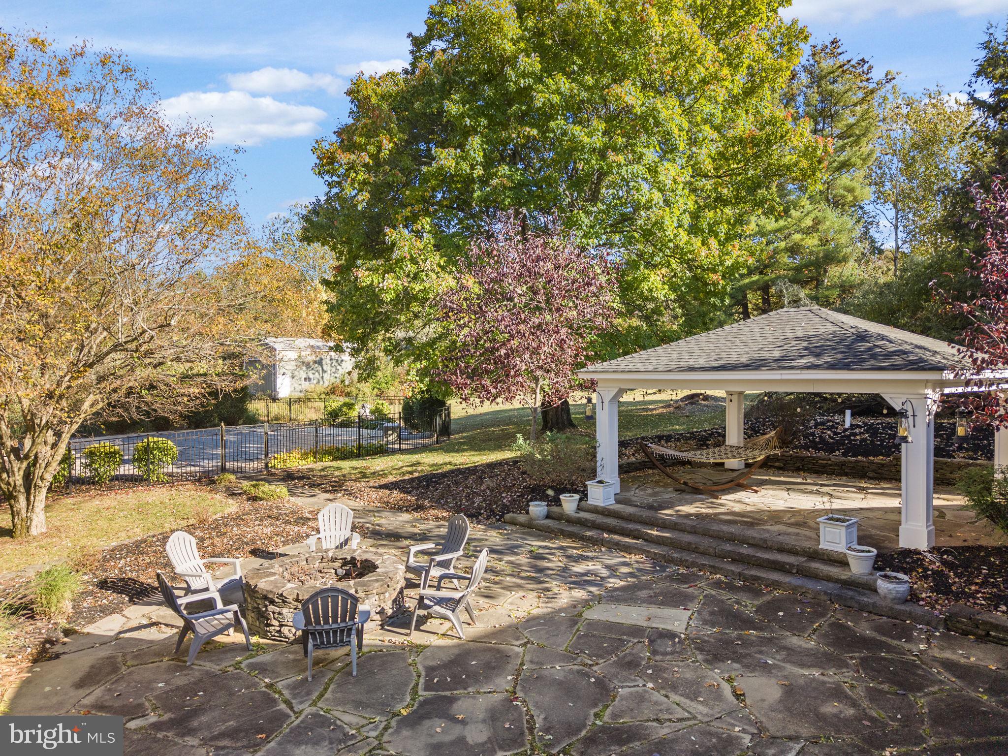 623 Montgomery Road Hillsborough, NJ 08844 - Photo 51 of 67 a view of a patio with a table and chairs under an umbrella