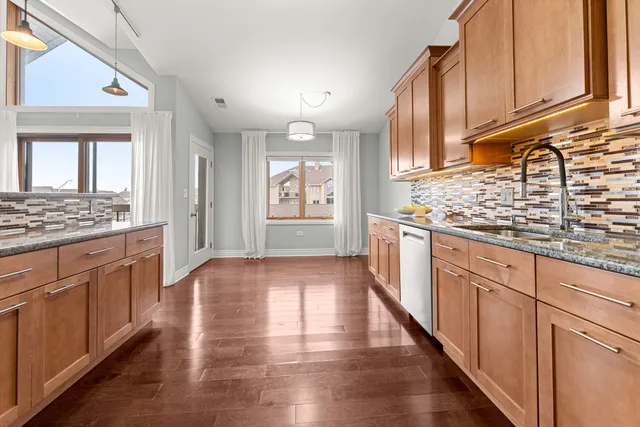 a view of kitchen with granite countertop cabinets and wooden floor