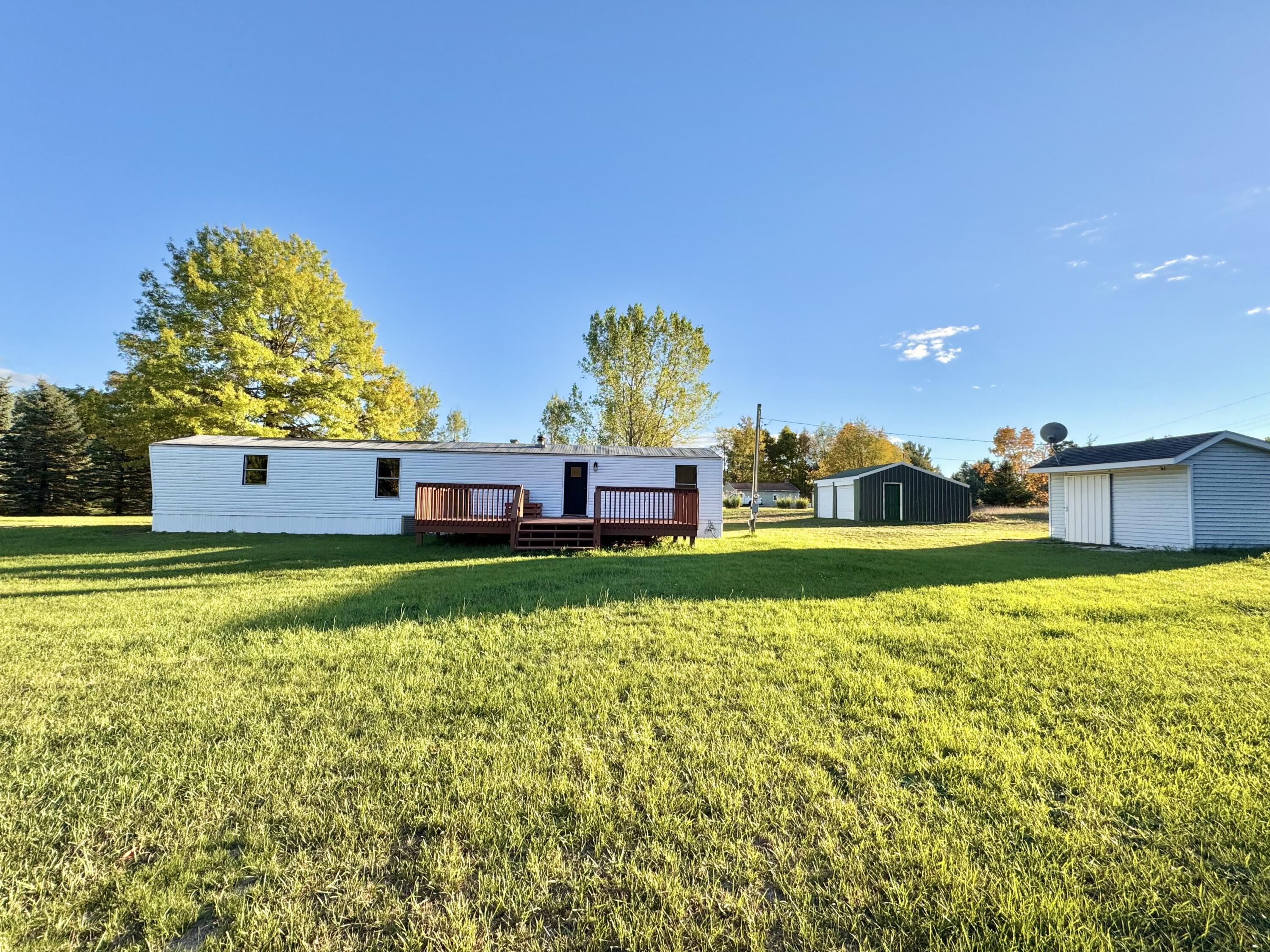 16303 Ritchie Avenue Northeast Sand Lake, MI 49343 - Photo 15 of 18 Back View with Deck