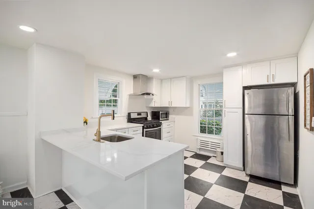 a kitchen with stainless steel appliances a refrigerator sink and microwave