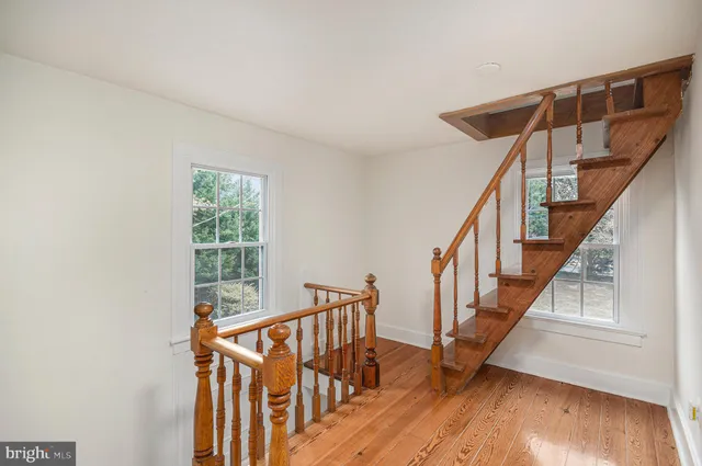 a view of entryway with wooden floor and stairs