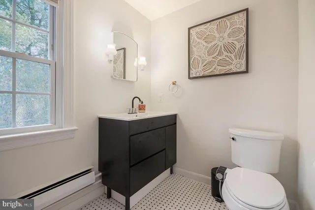 a bathroom with a toilet sink and vanity