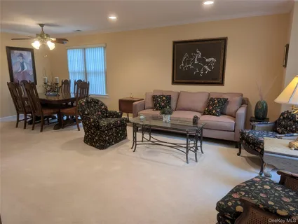 a living room with furniture a couch and a potted plant