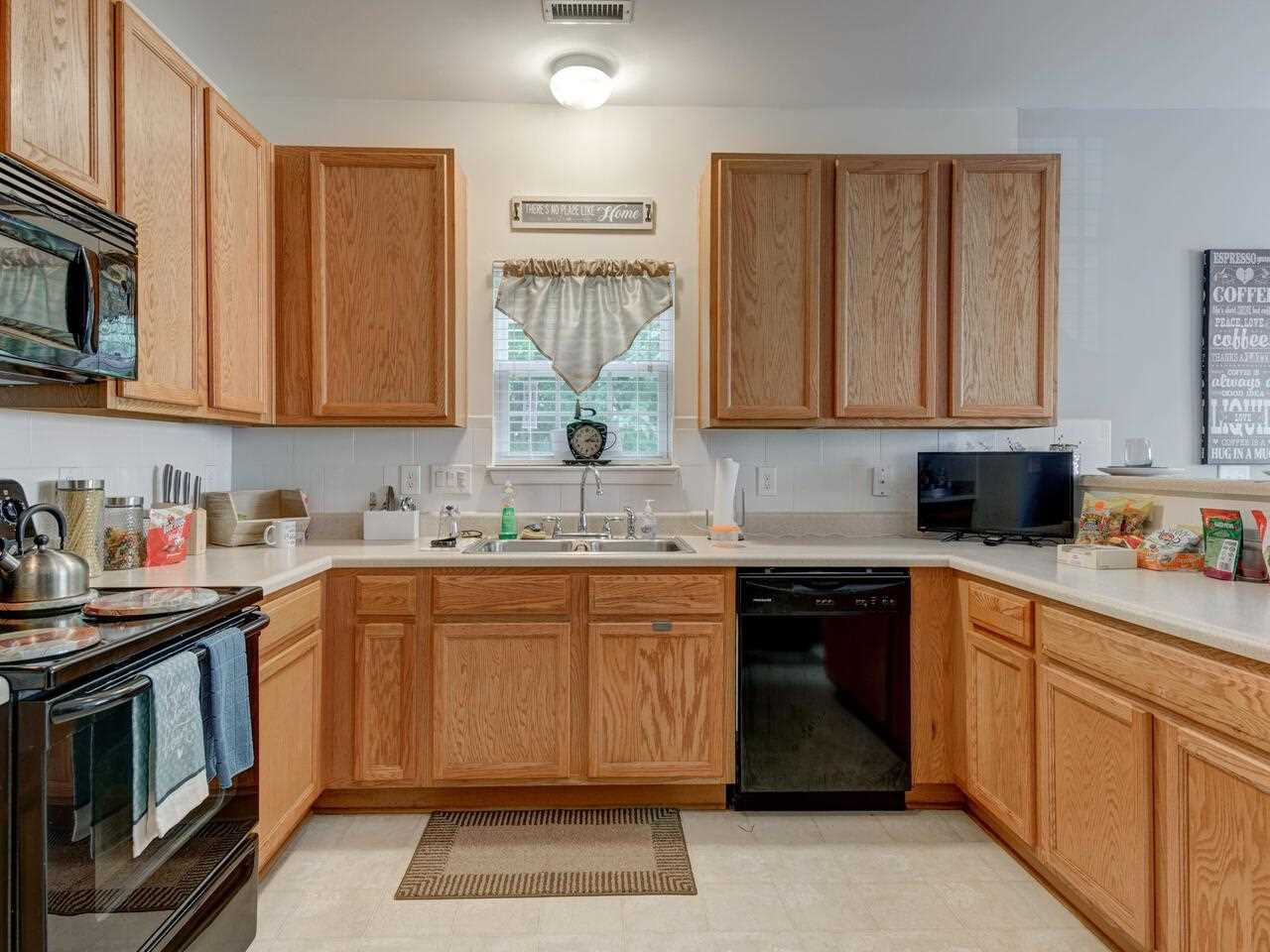 3536 Oneonta Avenue Raleigh, NC 27604 - Photo 8 of 22 a kitchen with stainless steel appliances granite countertop a sink stove and microwave