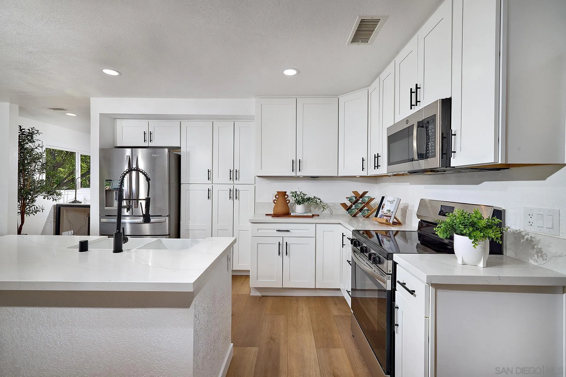 6185 Alpine Boulevard Alpine, CA 91901 - Photo 1 of 39 a kitchen with stainless steel appliances granite countertop a refrigerator sink and white cabinets