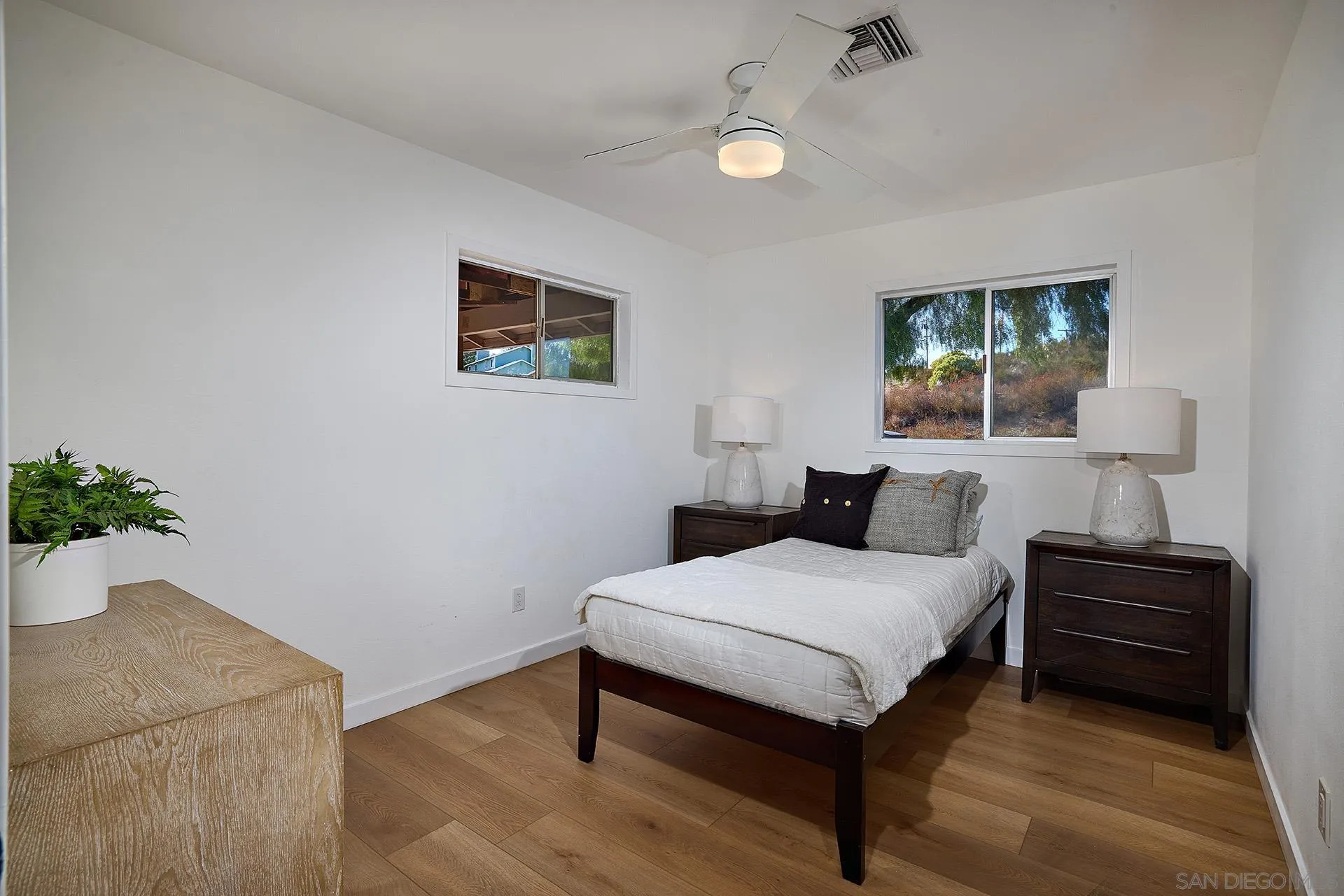 6185 Alpine Boulevard Alpine, CA 91901 - Photo 14 of 39 a bedroom with a bed and a potted plant