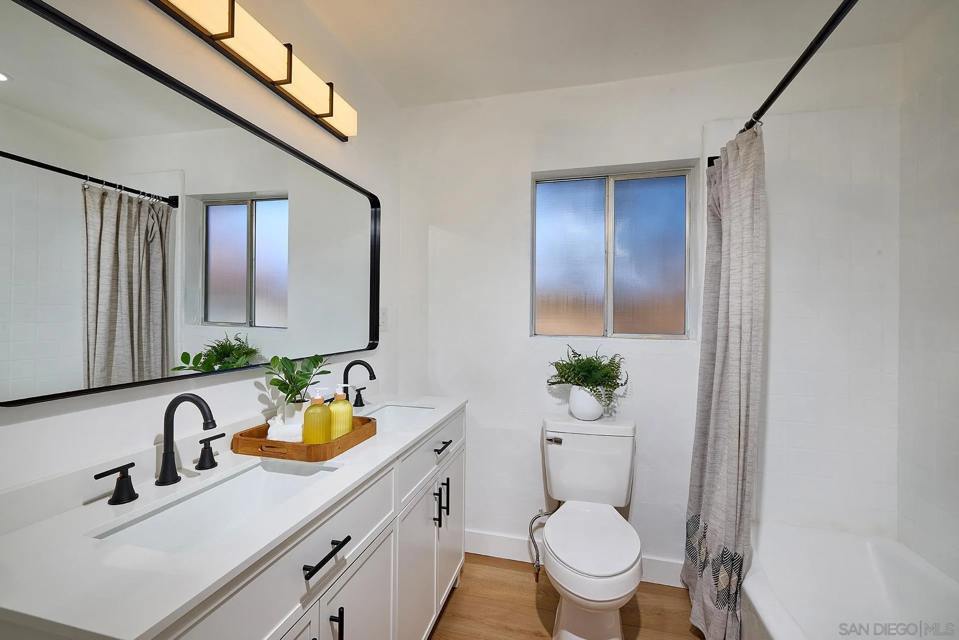 6185 Alpine Boulevard Alpine, CA 91901 - Photo 15 of 39 a bathroom with a toilet a sink and a mirror