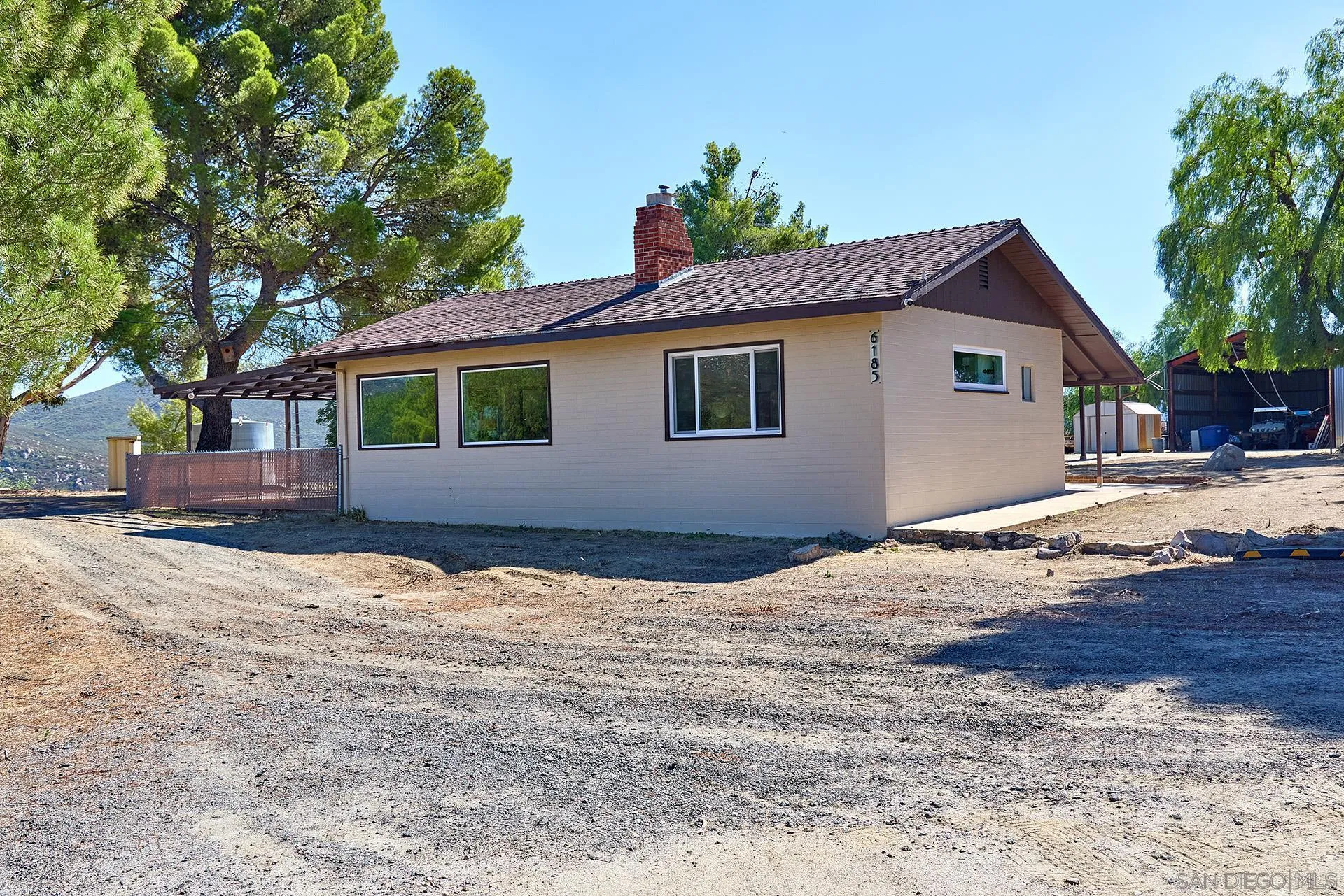 6185 Alpine Boulevard Alpine, CA 91901 - Photo 20 of 39 a house with trees in the background
