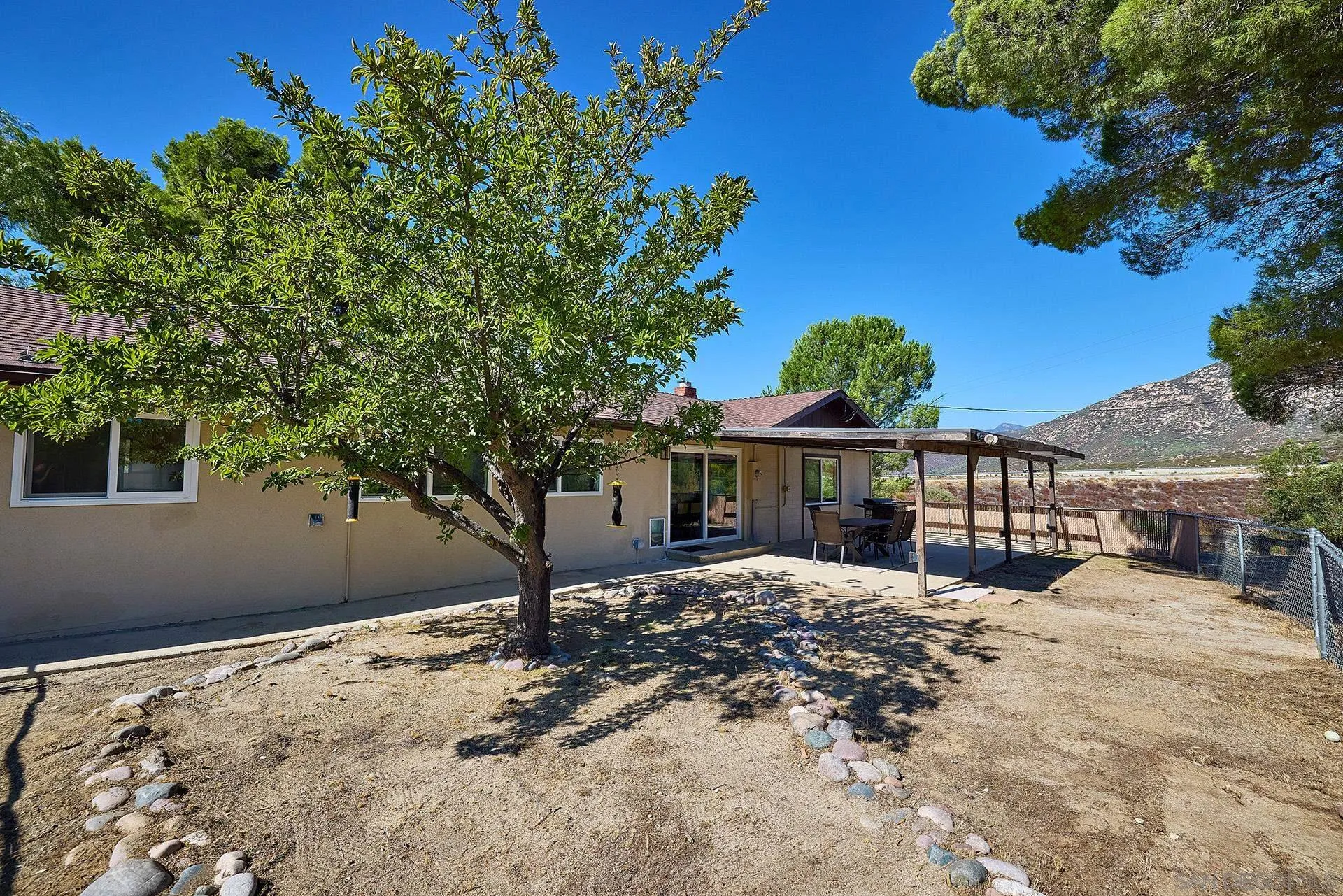 6185 Alpine Boulevard Alpine, CA 91901 - Photo 28 of 39 a view of a house with a tree in the background