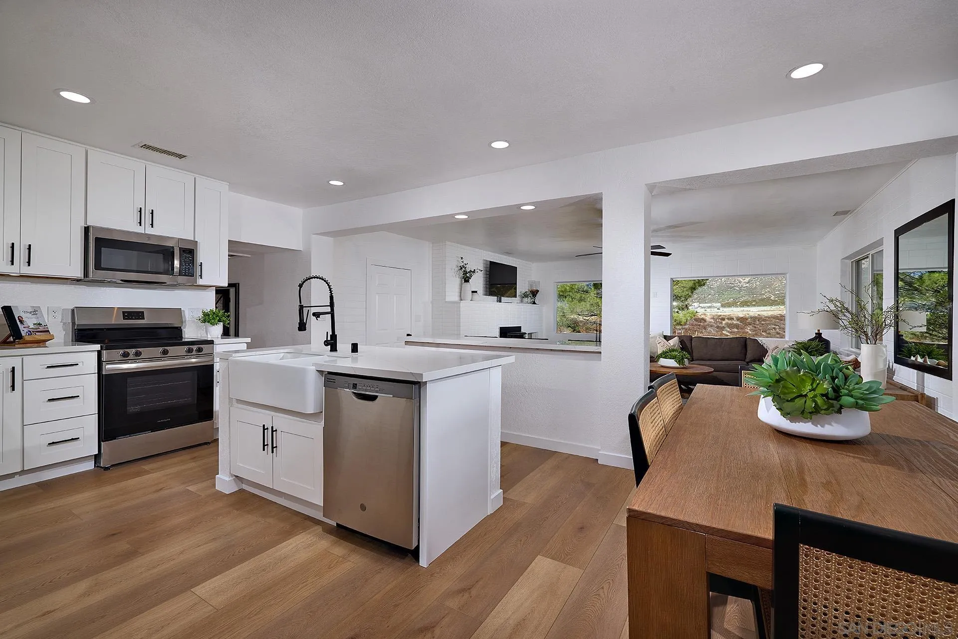 6185 Alpine Boulevard Alpine, CA 91901 - Photo 3 of 39 a kitchen with sink a microwave and cabinets