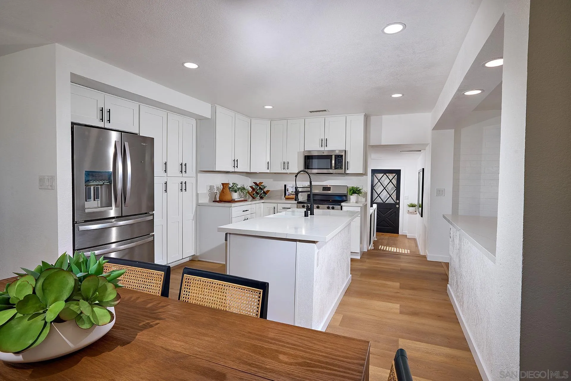 6185 Alpine Boulevard Alpine, CA 91901 - Photo 4 of 39 a kitchen with white cabinets and stainless steel appliances