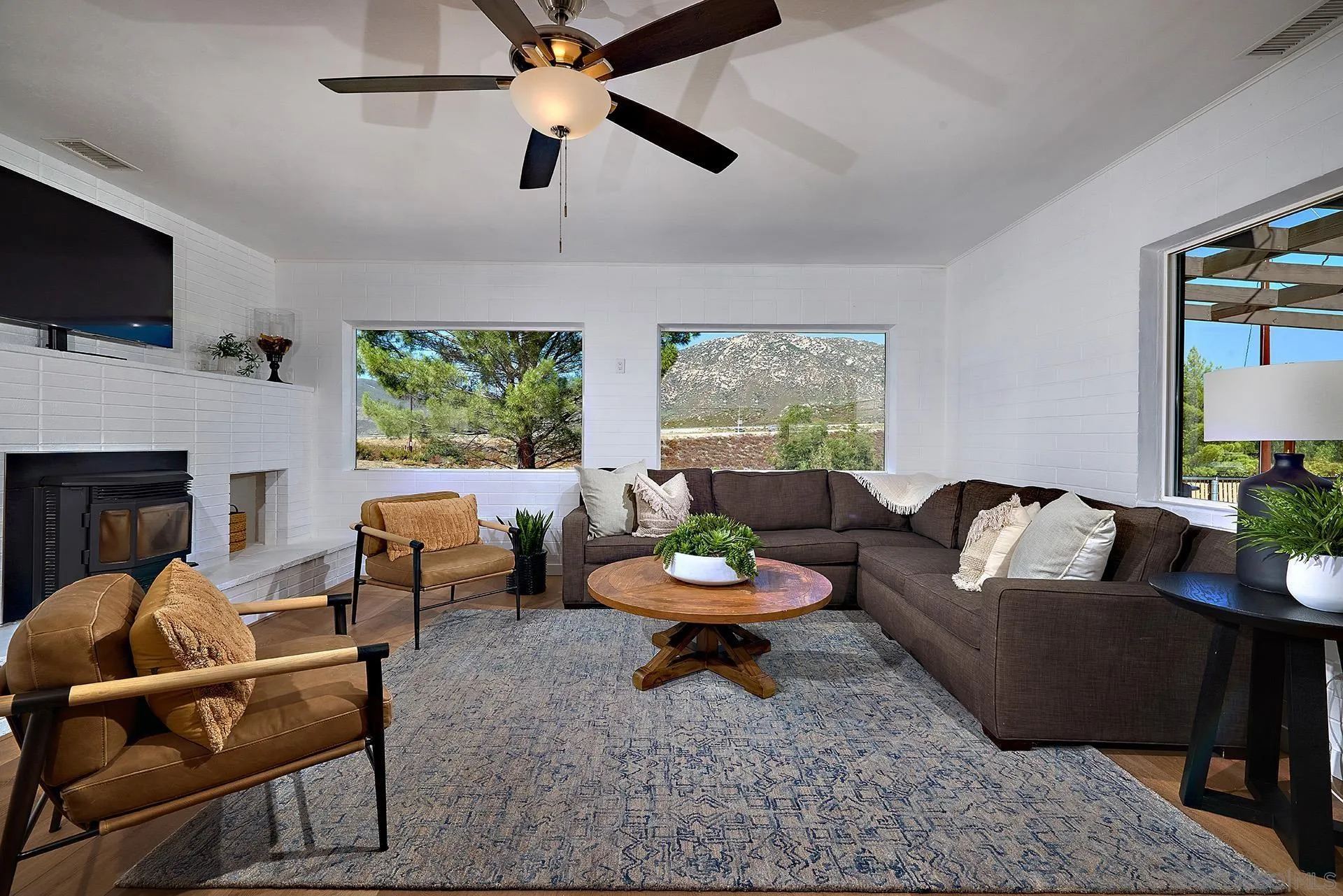 6185 Alpine Boulevard Alpine, CA 91901 - Photo 6 of 39 a living room with furniture and a flat screen tv