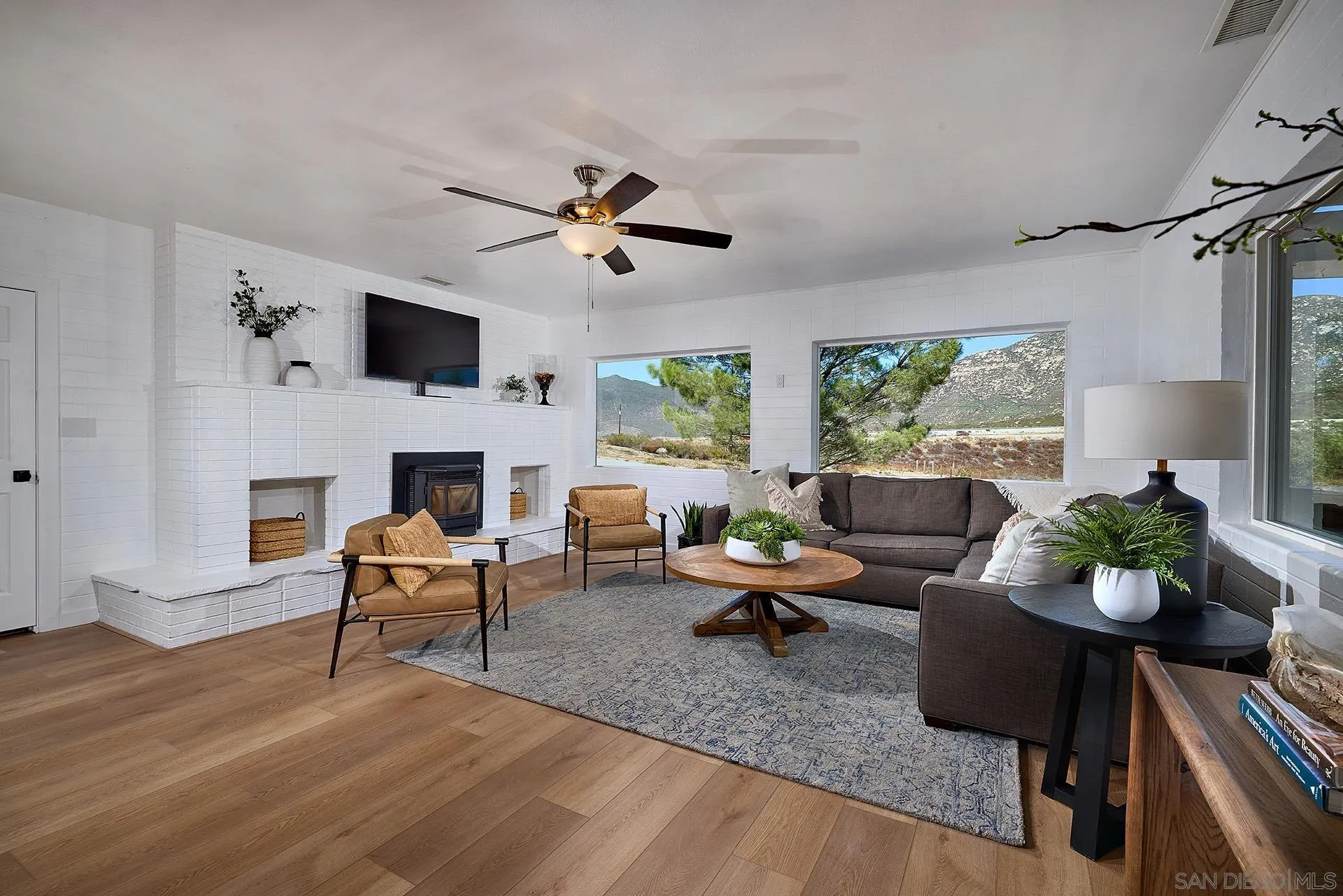 6185 Alpine Boulevard Alpine, CA 91901 - Photo 7 of 39 a living room with furniture fireplace and a flat screen tv