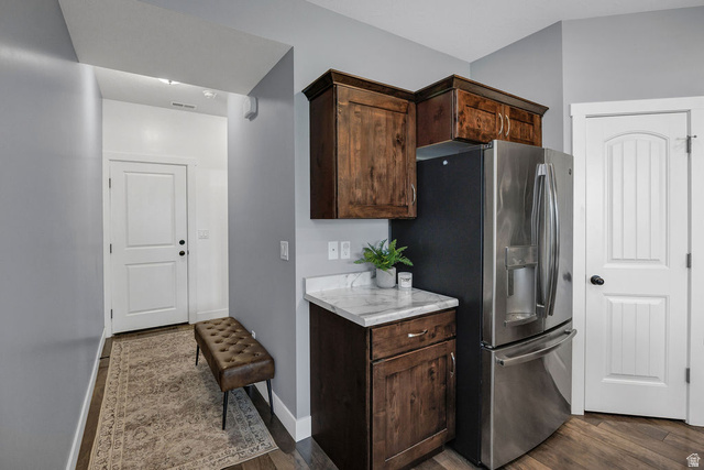 2483 South 1296th Street West Logan, UT 84321 - Photo 12 of 45 Stainless steel French door refrigerator set against a gray wall with wood-finish flooring