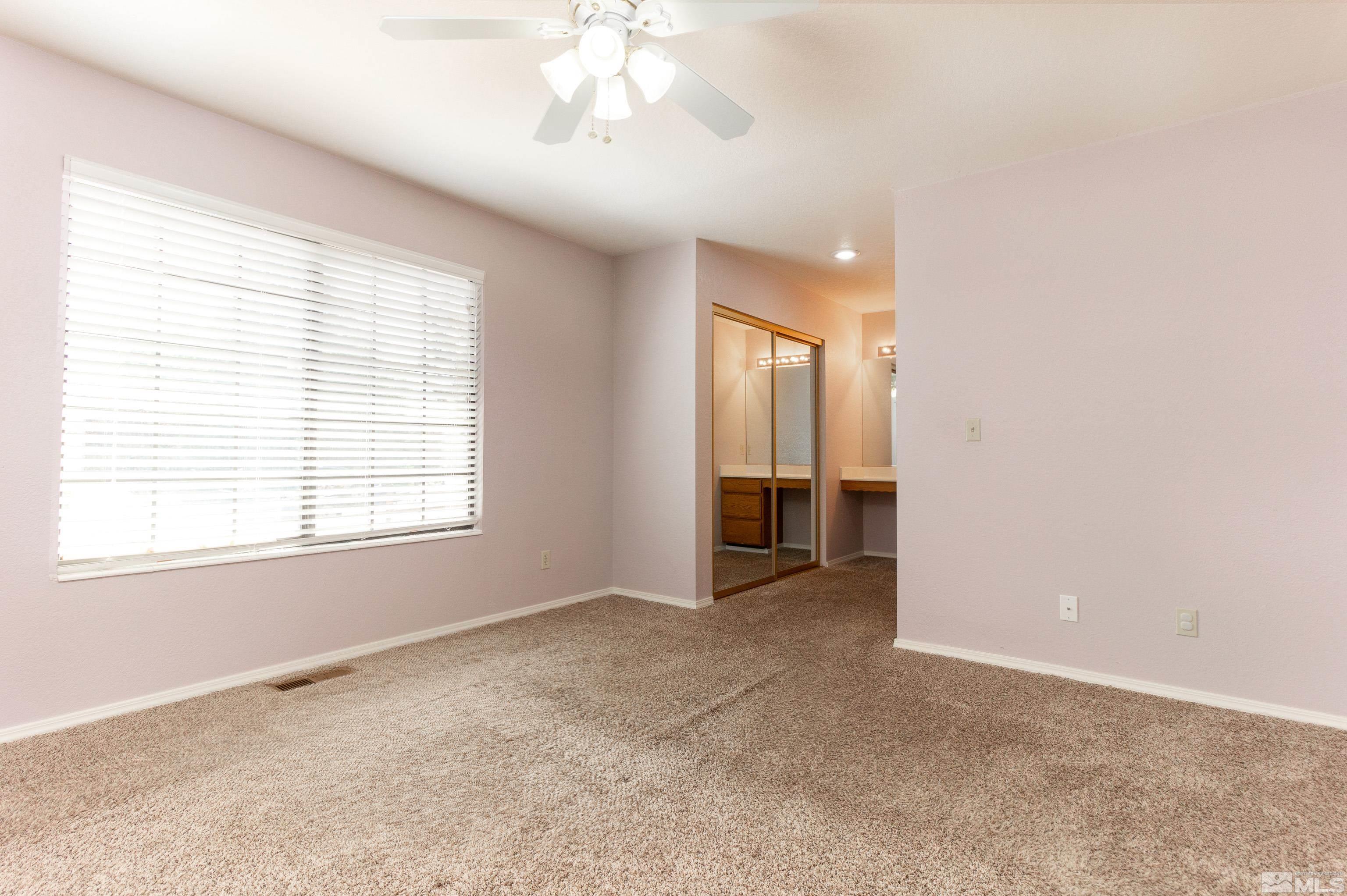 5331 Coit Drive Reno, NV 89523 - Photo 11 of 28 an empty room with chandelier fan and windows