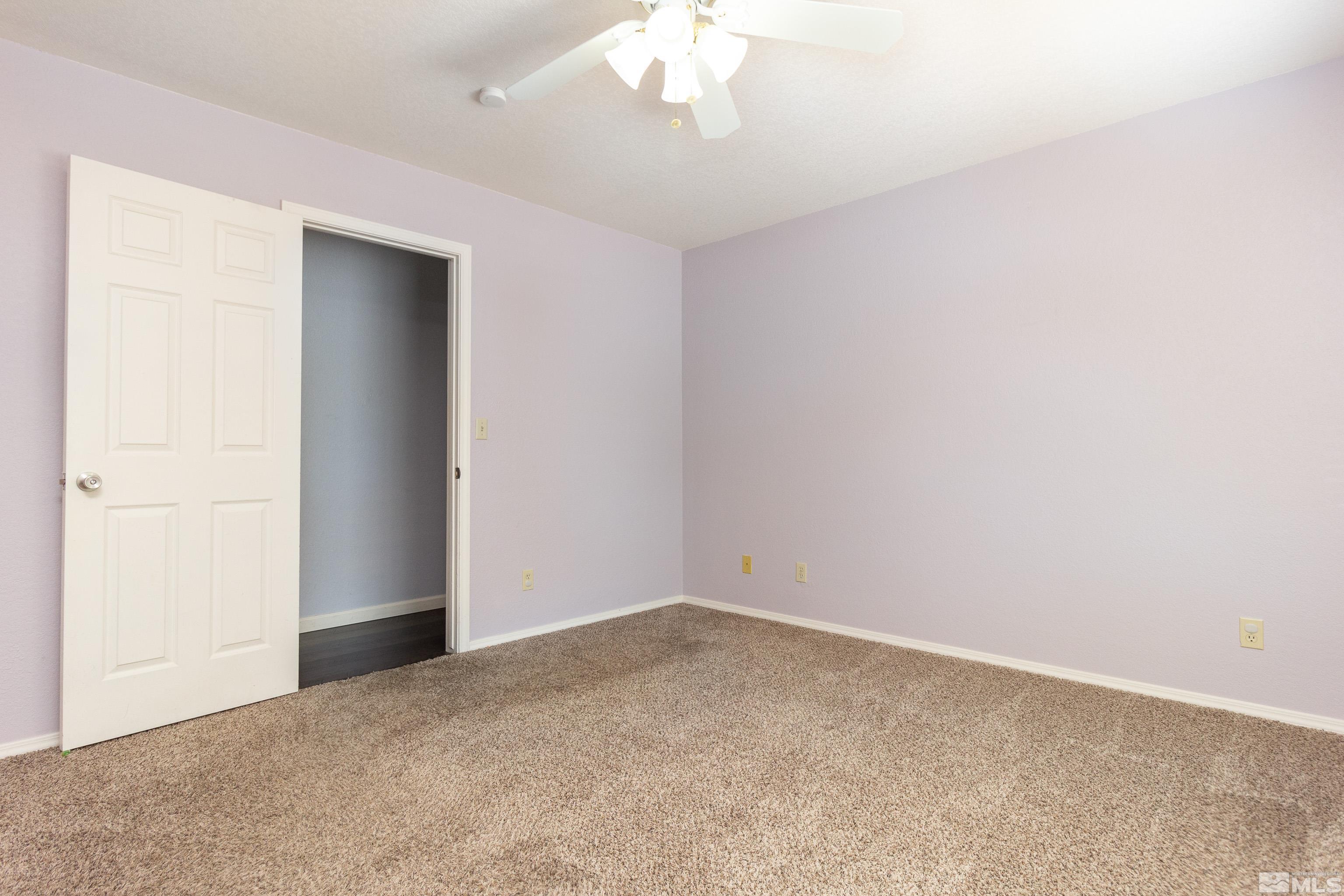5331 Coit Drive Reno, NV 89523 - Photo 12 of 28 an empty room with a chandelier fan