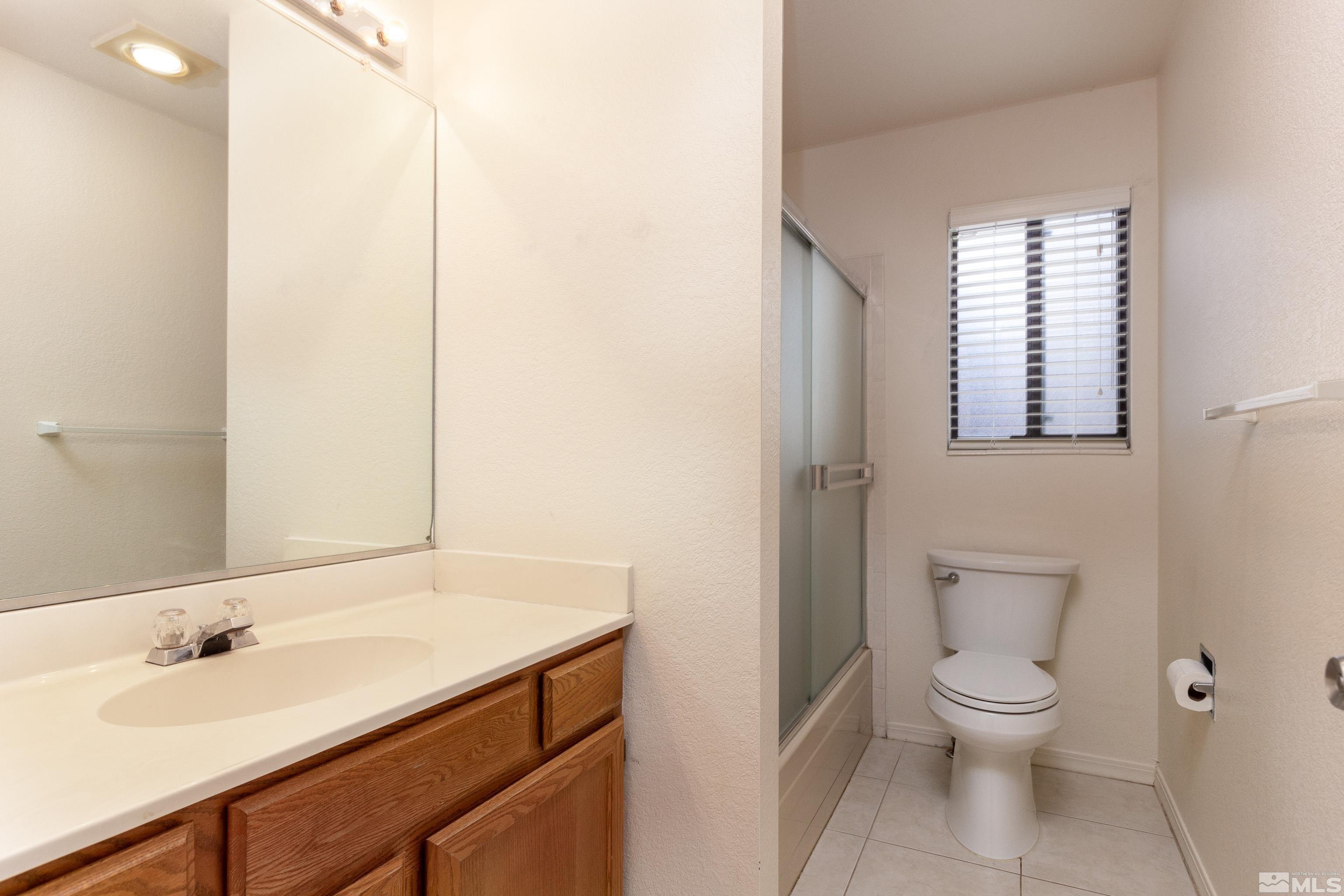 5331 Coit Drive Reno, NV 89523 - Photo 15 of 28 a bathroom with a toilet a sink and a mirror
