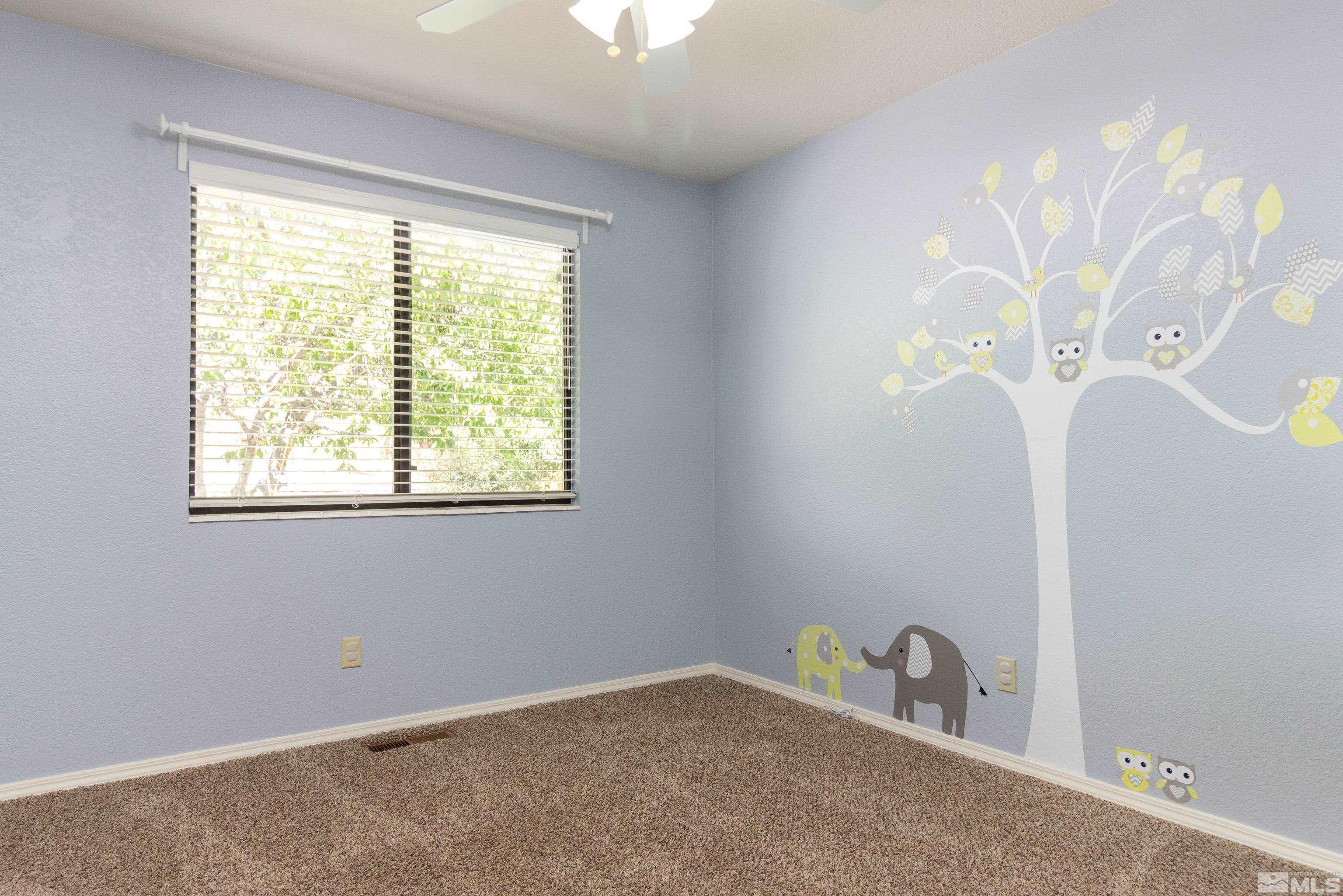 5331 Coit Drive Reno, NV 89523 - Photo 17 of 28 a room with a window and a chandelier fan