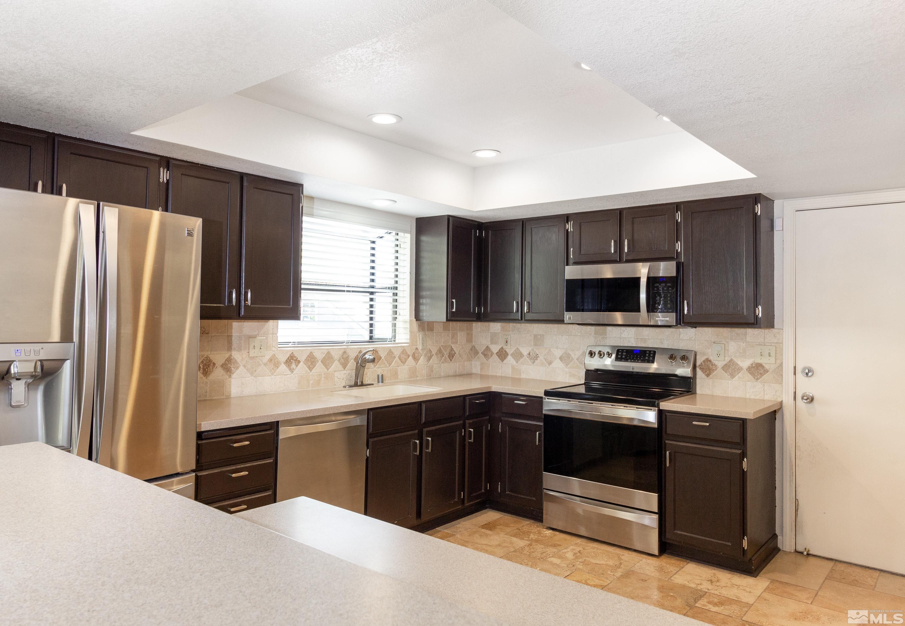5331 Coit Drive Reno, NV 89523 - Photo 22 of 28 a kitchen with stainless steel appliances granite countertop a sink stove and refrigerator