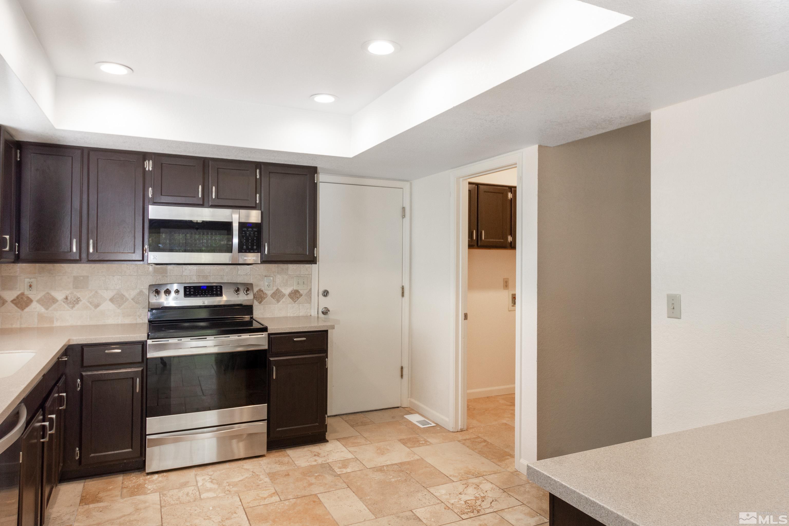 5331 Coit Drive Reno, NV 89523 - Photo 23 of 28 a kitchen with stainless steel appliances a stove a microwave and a sink