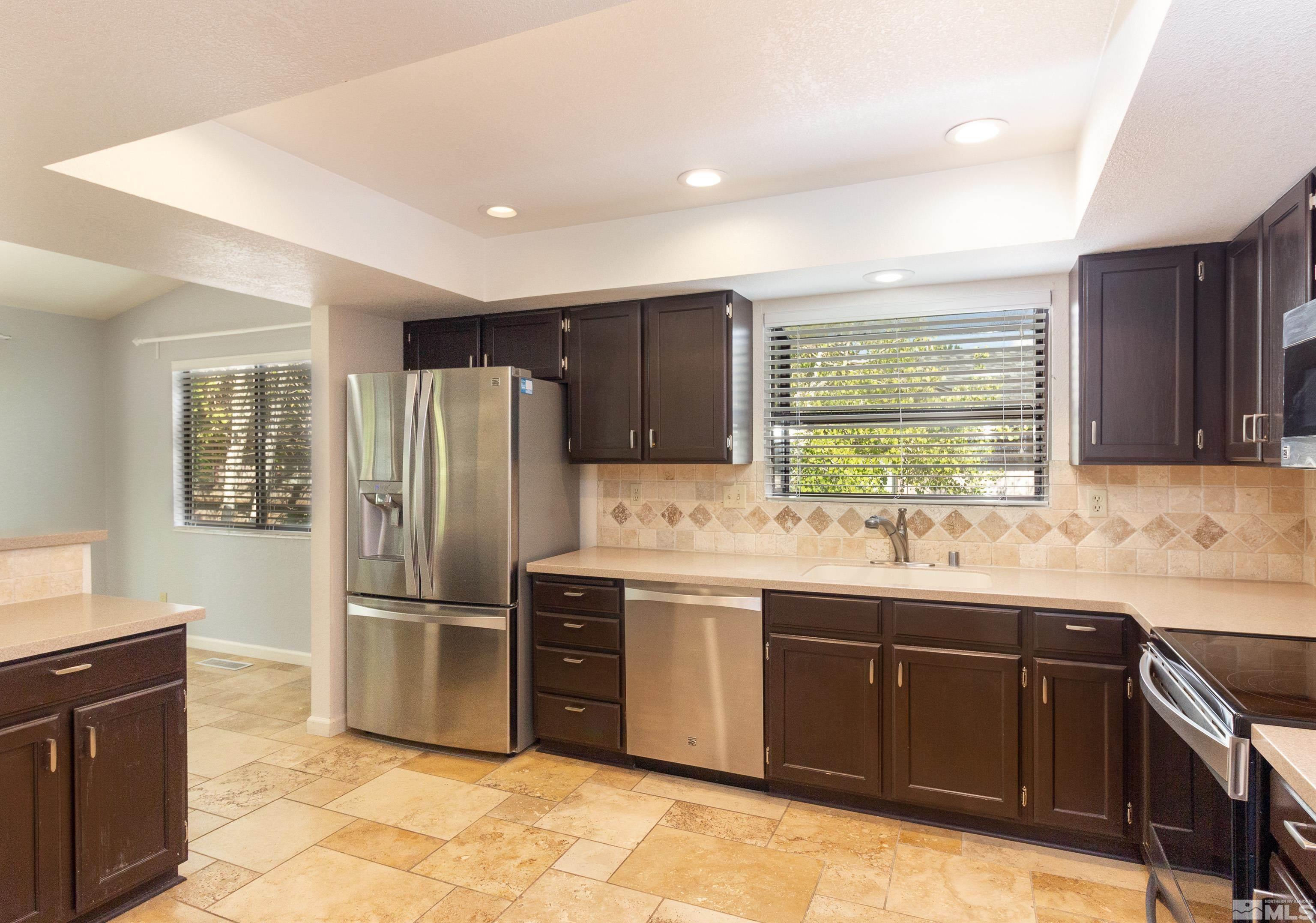 5331 Coit Drive Reno, NV 89523 - Photo 24 of 28 a kitchen with stainless steel appliances granite countertop a sink stove and refrigerator