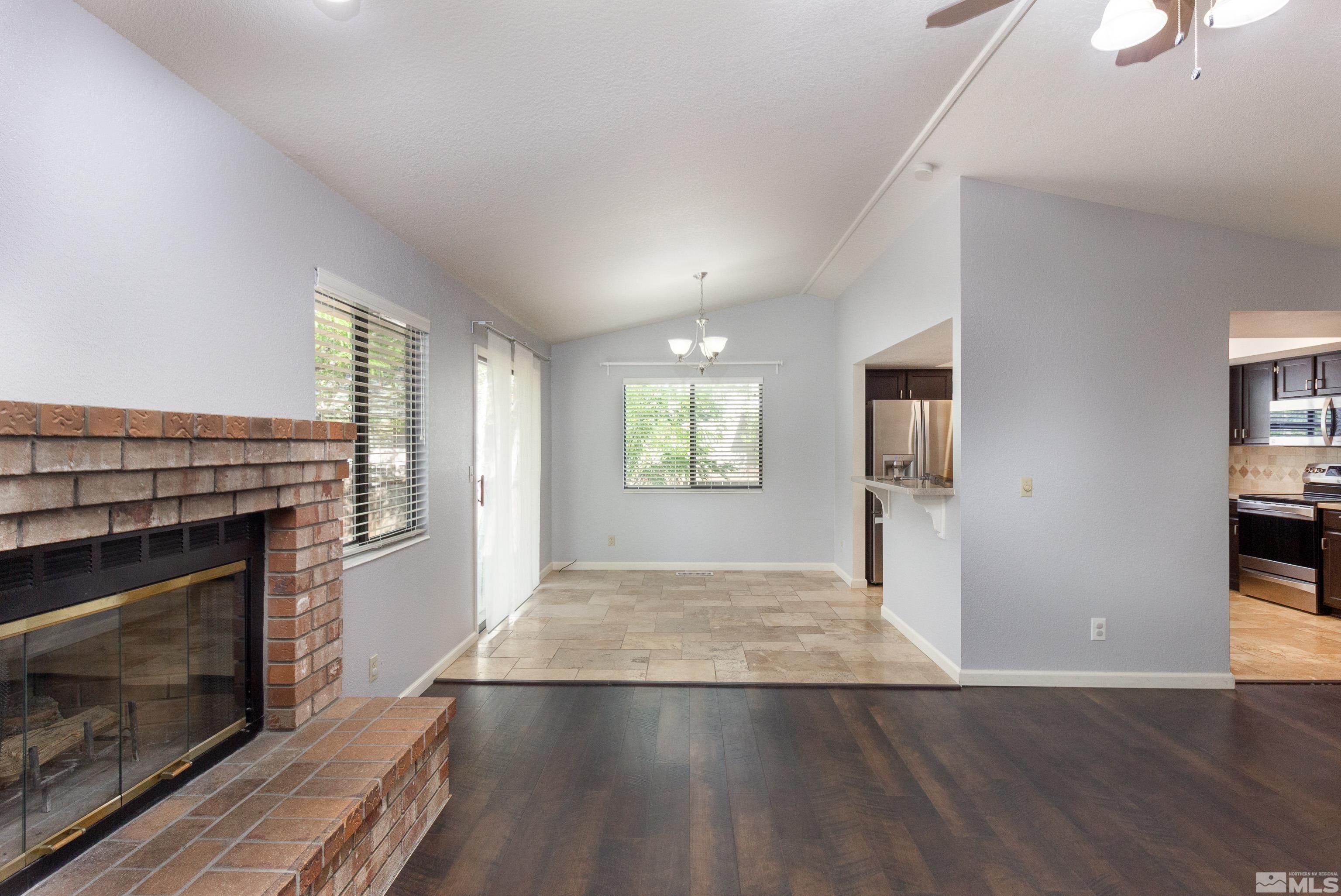 5331 Coit Drive Reno, NV 89523 - Photo 25 of 28 a view of empty room with wooden floor and fireplace