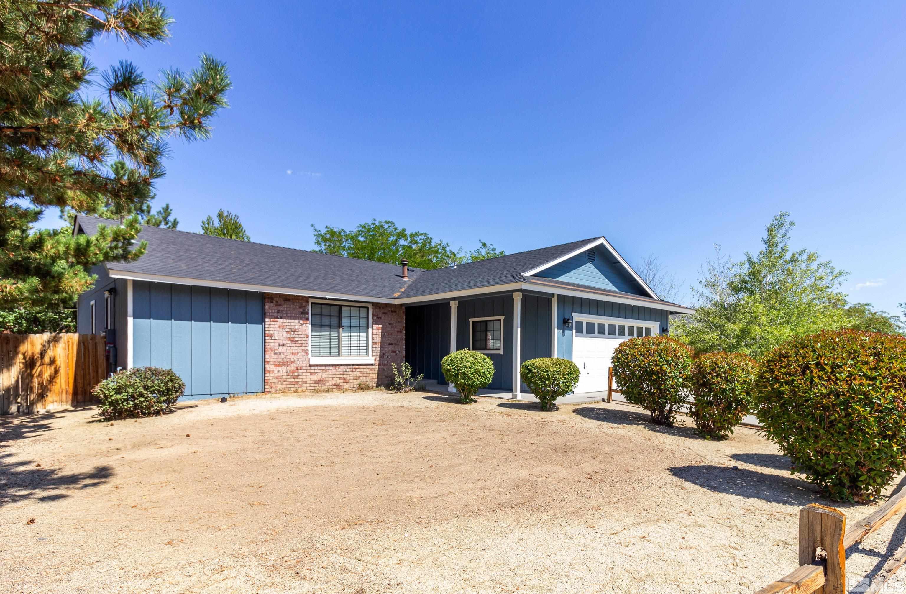 5331 Coit Drive Reno, NV 89523 - Photo 3 of 28 a front view of a house with a yard and potted plants