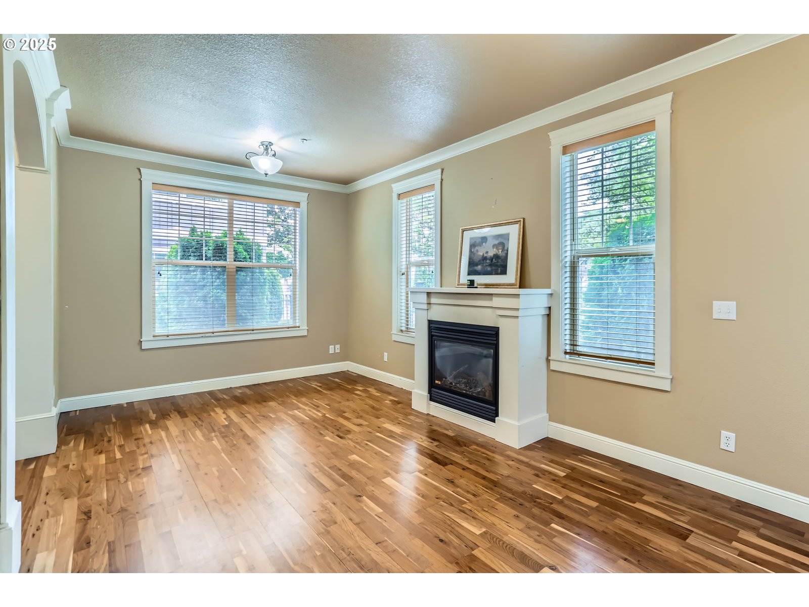 343 Northeast Bryant Street Portland, OR 97211 - Photo 8 of 26 a view of an empty room with window and wooden floor