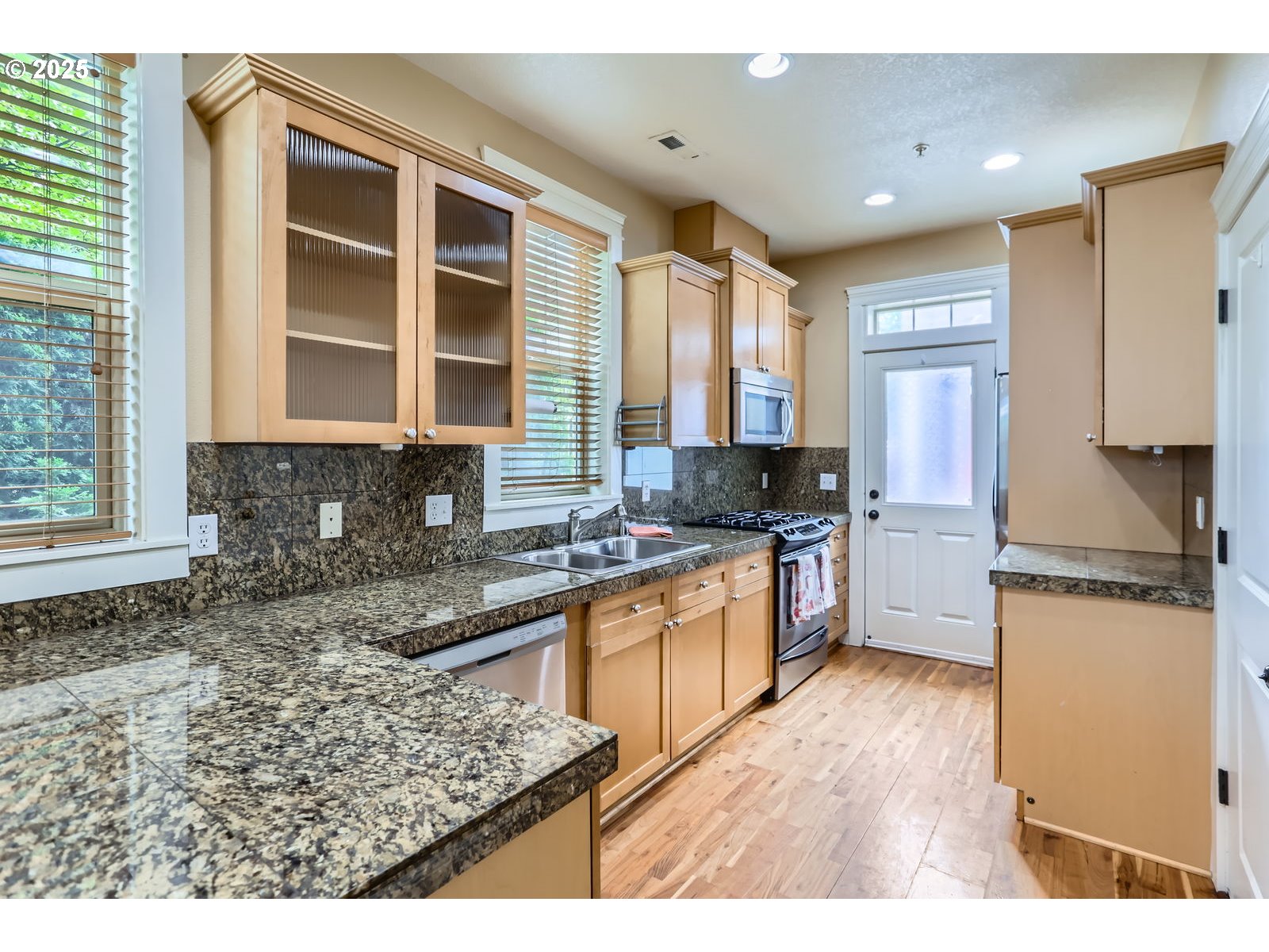 343 Northeast Bryant Street Portland, OR 97211 - Photo 10 of 26 a kitchen with stainless steel appliances granite countertop a stove a sink and a refrigerator