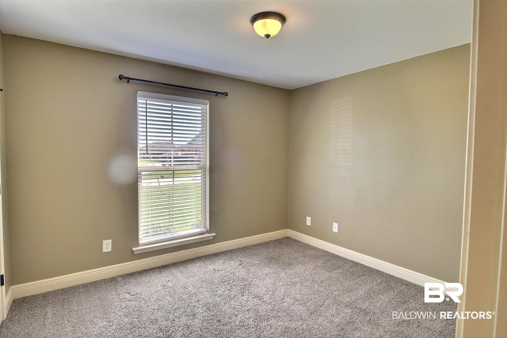 15577 Talus Court Foley, AL 36535 - Photo 14 of 28 Spare room with carpet floors and baseboards