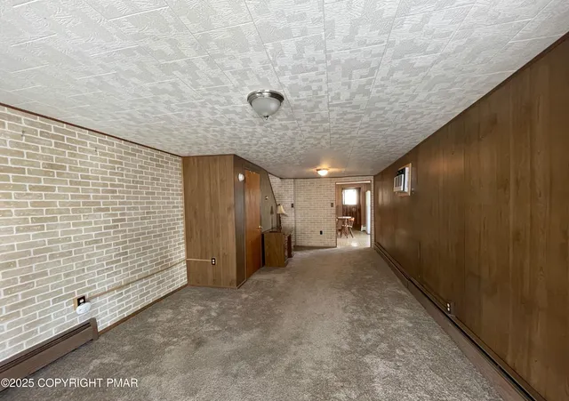 a view of a livingroom with an empty space and a window