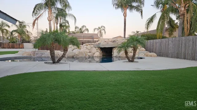 a front view of house with yard and car parked