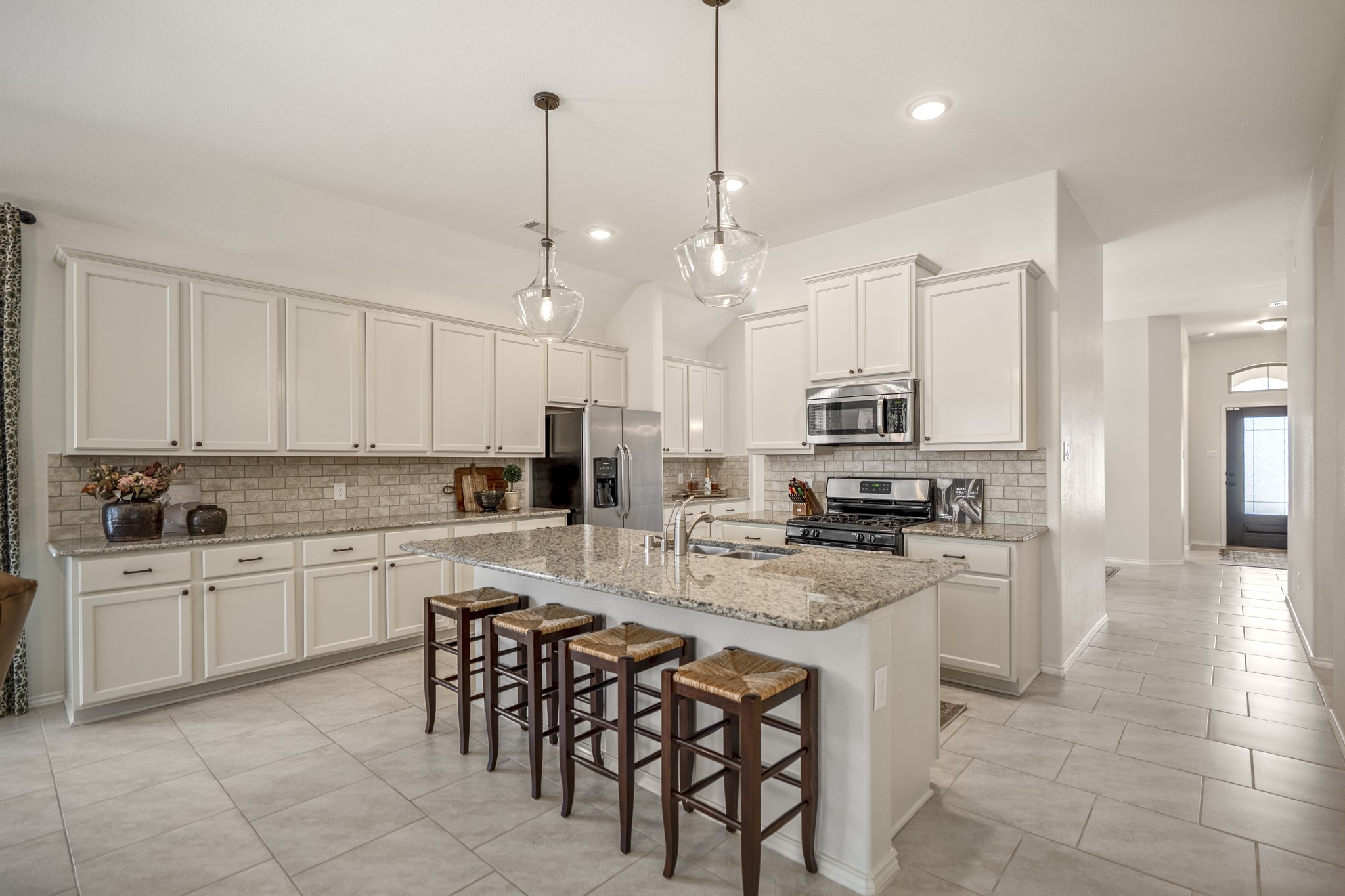 5522 Glenfield Spring Lane Spring, TX 77389 - Photo 4 of 46 This spacious kitchen features modern stainless steel appliances, a large granite island with seating, elegant pendant lighting, and ample cabinet storage.