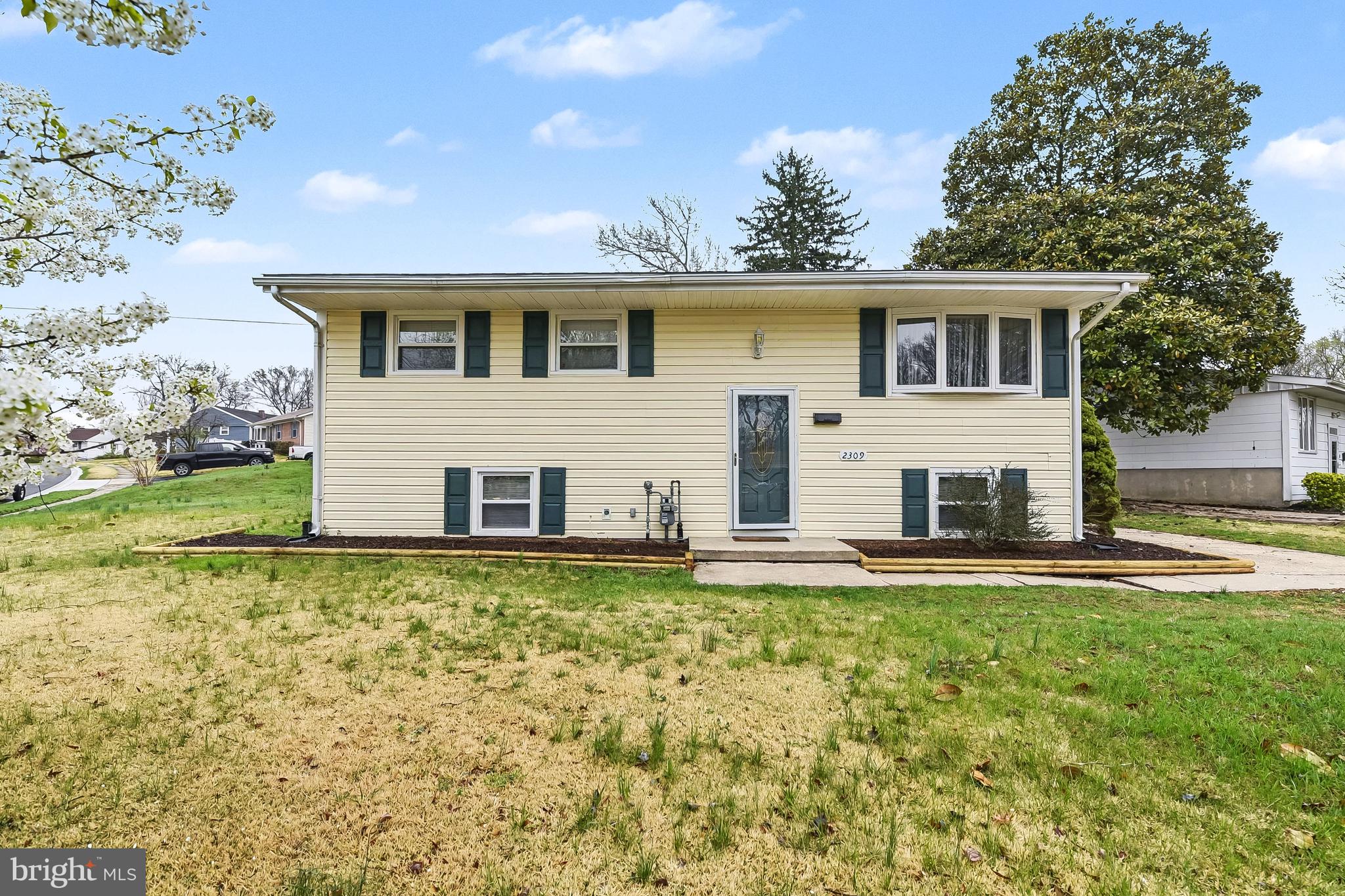 a front view of a house with a garden