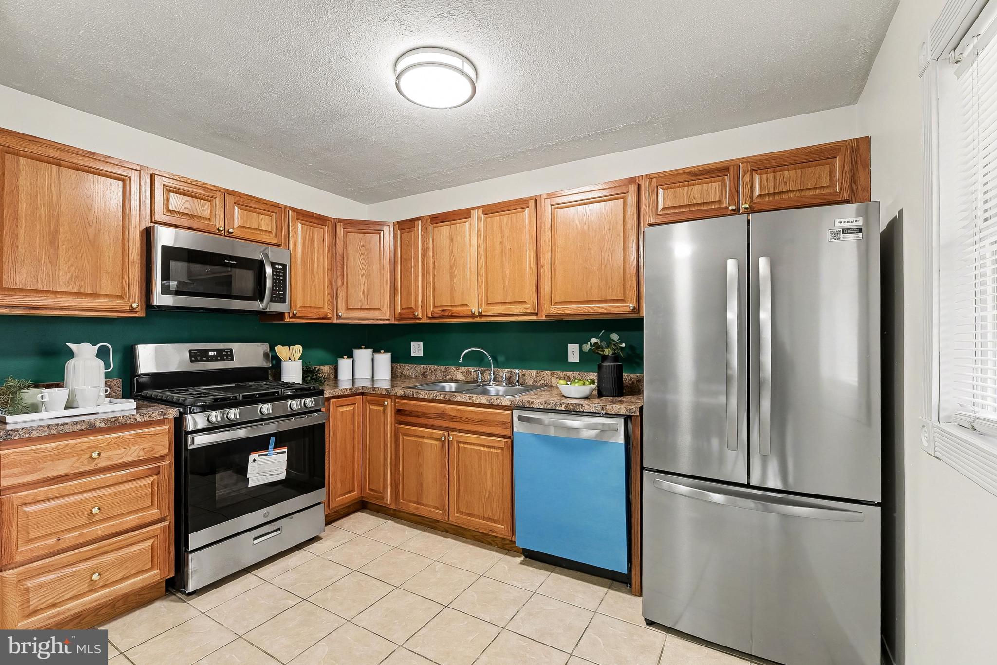 2309 Perry Avenue Edgewood, MD 21040 - Photo 9 of 25 a kitchen with stainless steel appliances granite countertop a refrigerator a stove a sink and a microwave
