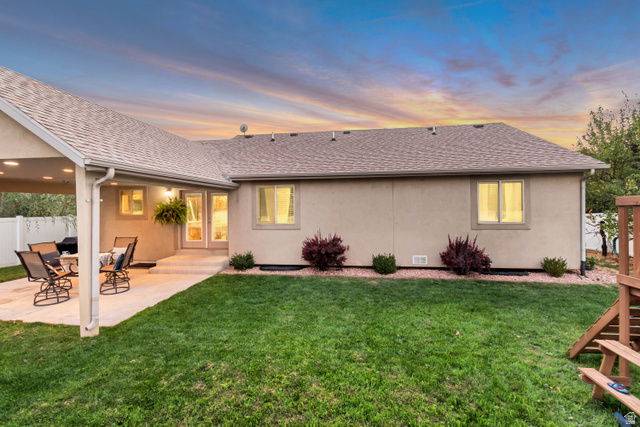 356 North 230 West Payson, UT 84651 - Photo 41 of 45 Expansive backyard featuring a manicured lawn, covered patio, stucco exterior, and white privacy fencing