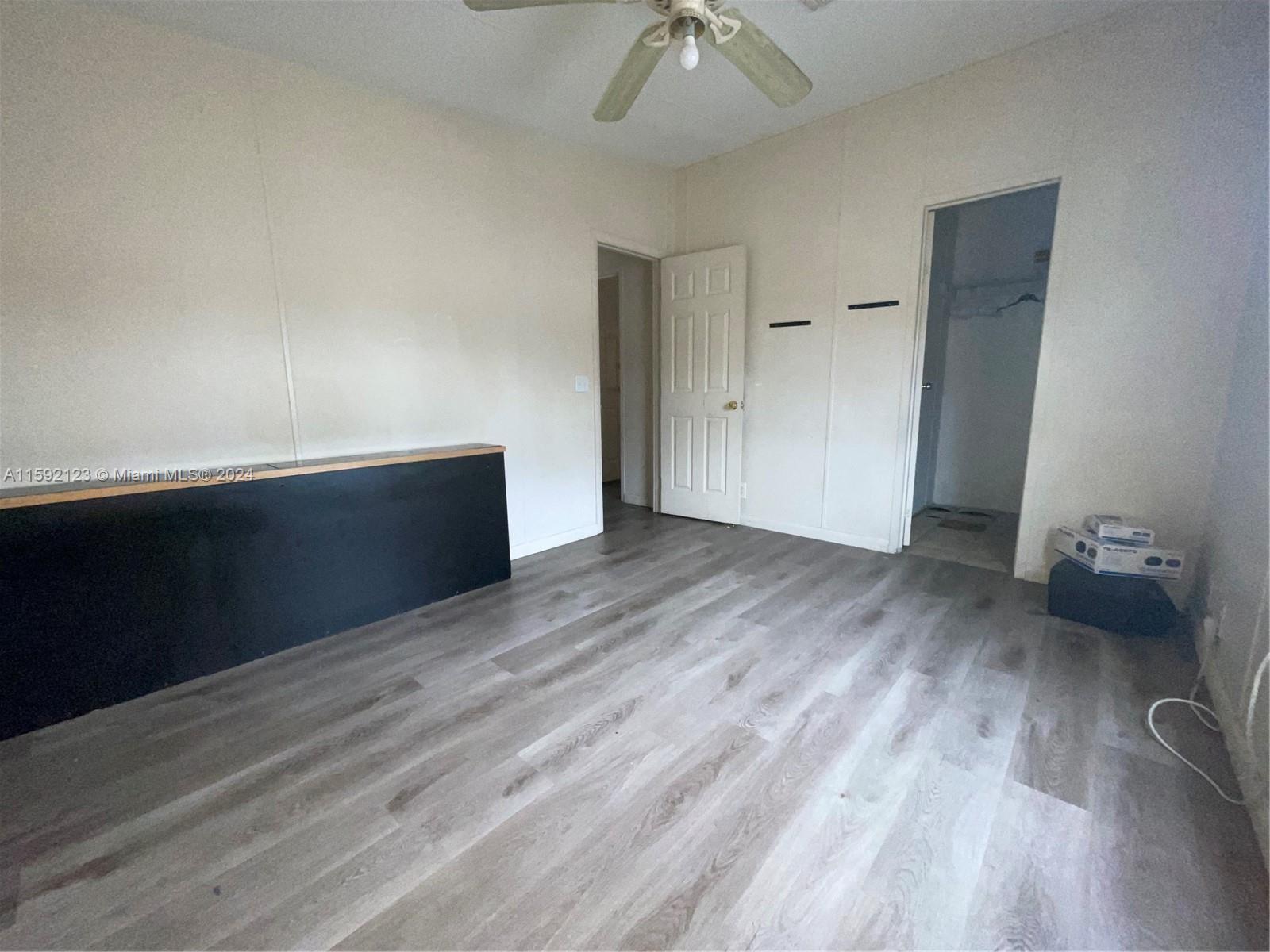 10128 Marlin Drive, Unit 1 Boca Raton, FL 33428 - Photo 16 of 17 a view of empty room with wooden floor