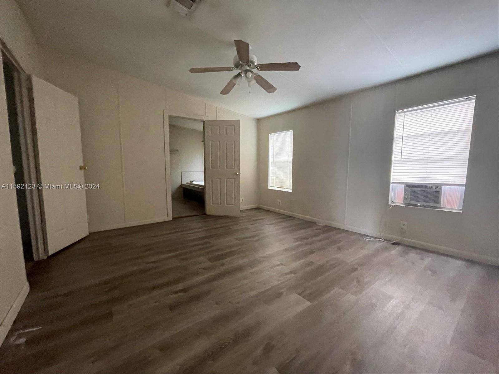 10128 Marlin Drive, Unit 1 Boca Raton, FL 33428 - Photo 8 of 17 wooden floor in an empty room with a window